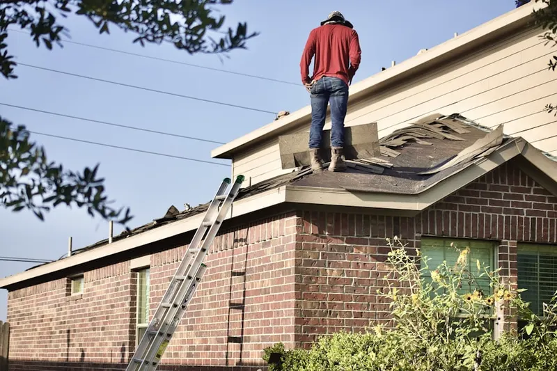 Professional roofer working on a residential roof in Tuckasegee